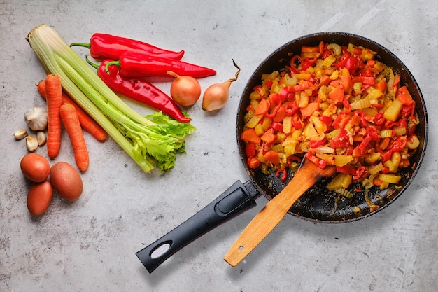 Raw ingredients and ready to eat vegetable ragout