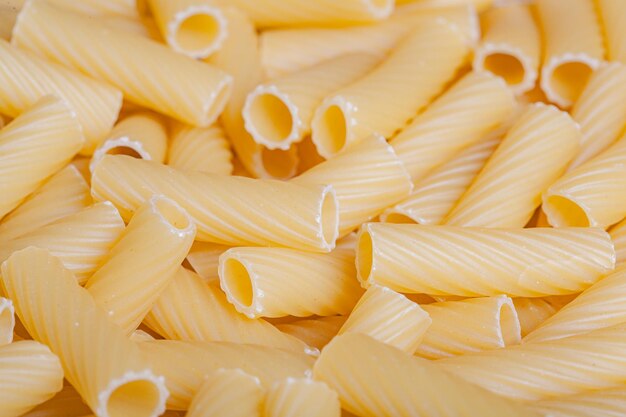 Raw italian durum wheat pasta tortiglioni background top view