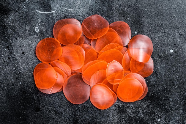 Raw kerupuk or prawn shrimp crackers chips Black background Top view