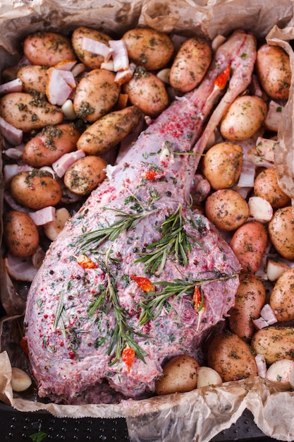 Raw lamb leg marinated with spices, garlic and rosemary