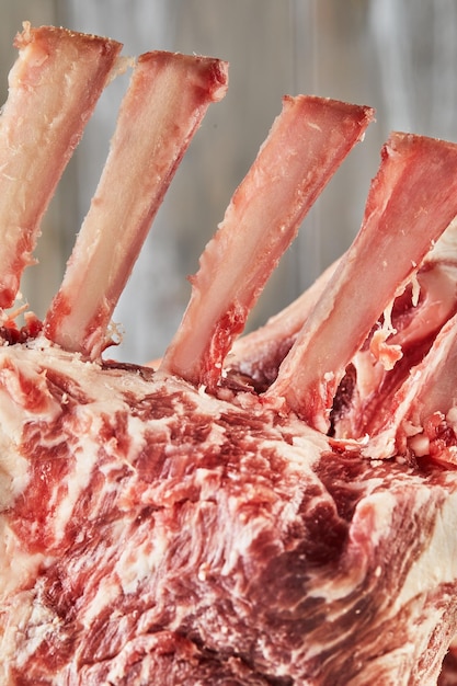 Raw lamb ribs on wooden board ready for cooking