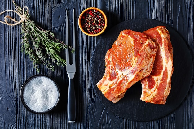 Raw marinated pork chops on a plate