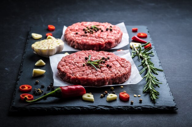 Raw meat burger cutlets with ingredients