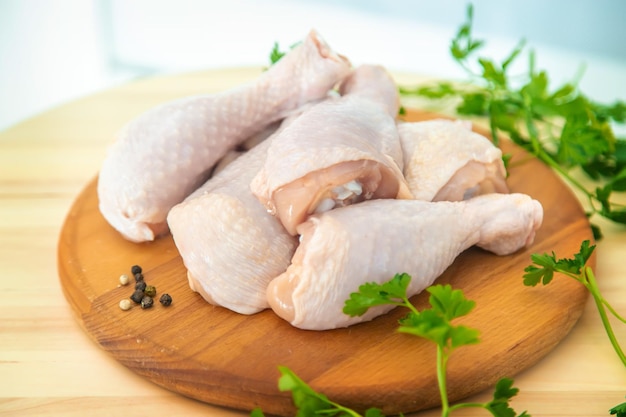 Raw meat chicken drumsticks on a board Selective focus