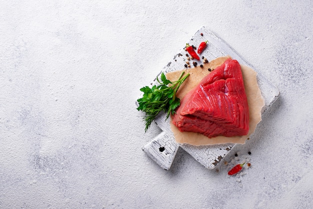 Raw meat on cutting board with spices 