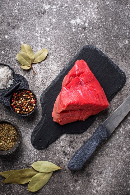 Raw meat on cutting board with spices