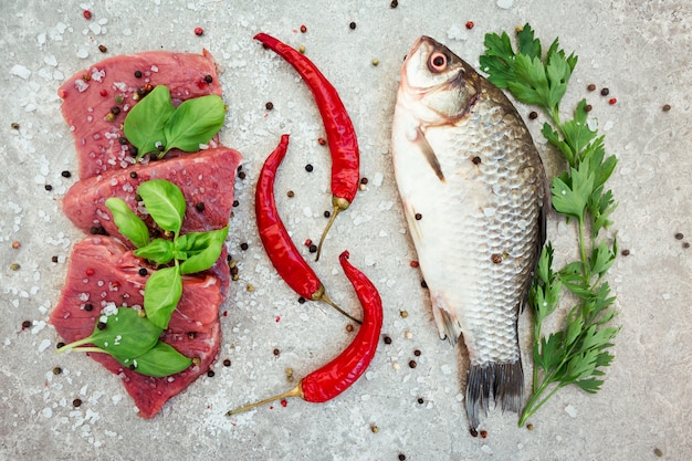 Raw meat and a fish on a table