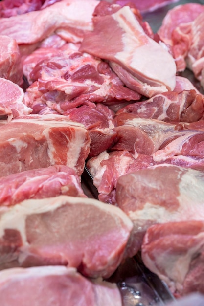 Raw meat pieces on the counter in the store Fresh semifinished products Closeup Vertical