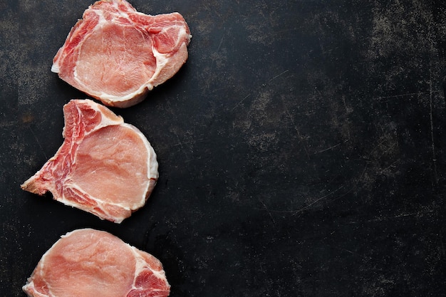 Raw meat pieces on dark background