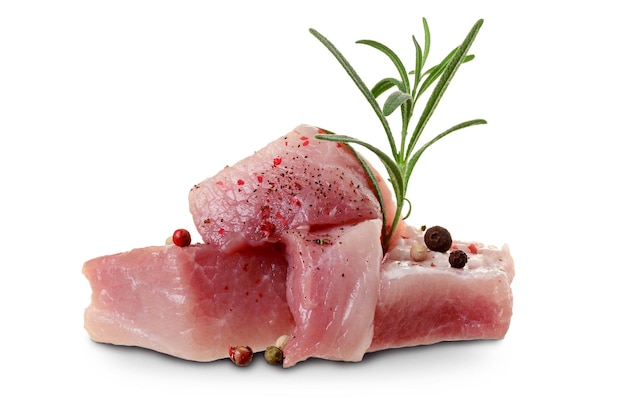 Raw meat pork or beef pieces with rosemary sprig and spices isolated on white background