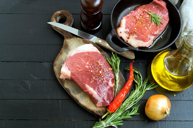 Raw meat. Raw beef steak on cutting Board and spices.