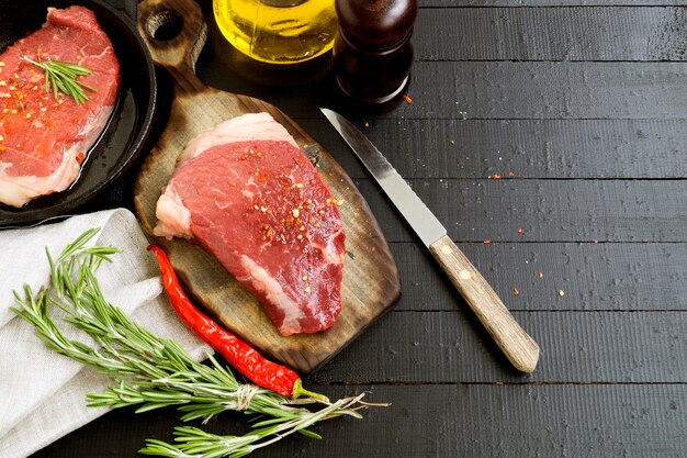 Raw meat. Raw beef steak on cutting Board and spices.