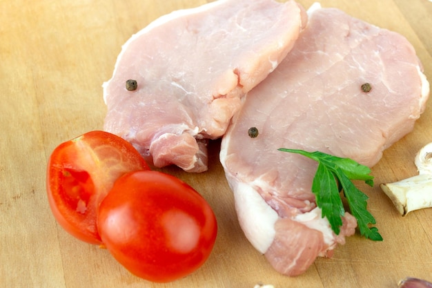 Raw meat Raw fillet of stuck with garlic tomato spice pepper champignon close up