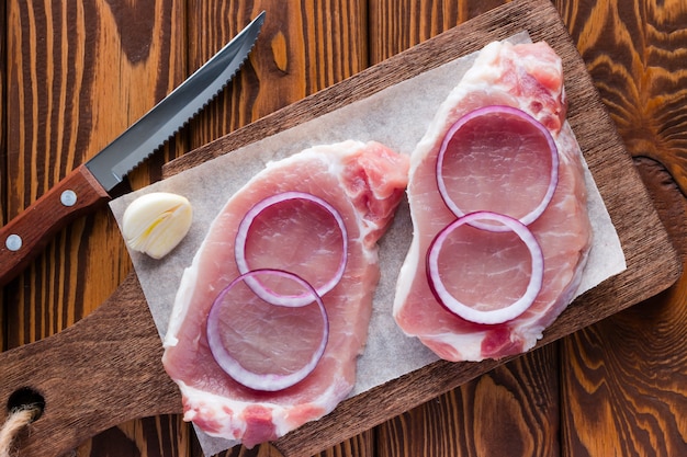 Raw meat with red onion and a knife