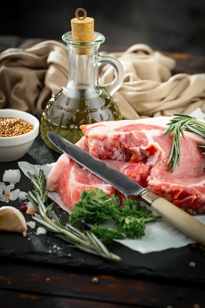 Raw meat with spices in a composition with kitchen accessories.