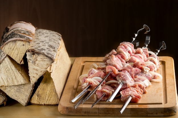 Raw meat with spices and onion strung on a skewer