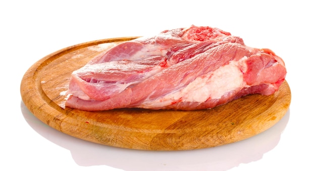 Raw meat on a wooden board isolated on white