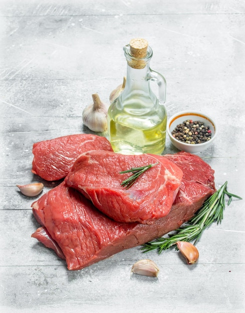 Raw meatPieces of beef with garlic rosemary and olive oil