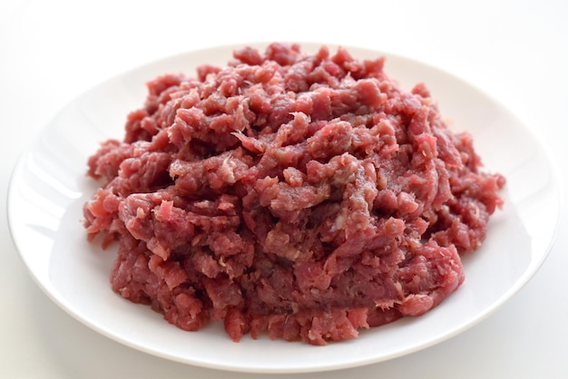 Raw minced beef on a white plate