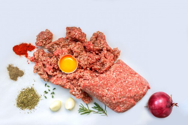 Raw minced meat with pepper, egg, herbs and  spices for cooking cutlets, burgers, meatballs. 