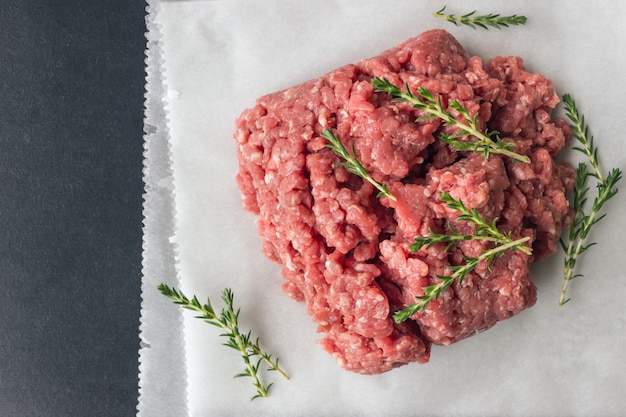 Raw minced meat with thyme and spices for cooking cutlets. 