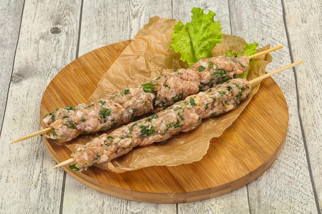 Raw minced pork skewer kebab for grill