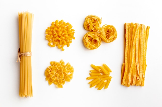 Raw mix of pasta on white background