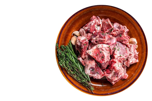 Raw mutton meat diced for goulash or stew with bone on a rustic plate High quality Isolate white background