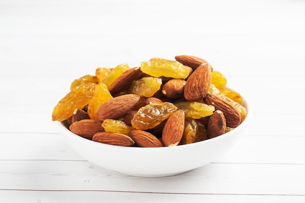 Raw nuts almonds and dried grapes raisins concept healthy snack