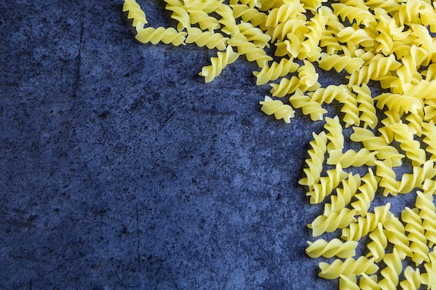 Raw pasta on blue