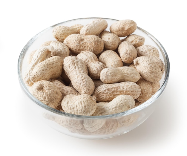 Raw peanuts in glass bowl isolated on white background with clipping path