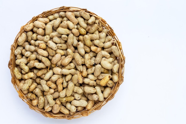 Raw peanuts on white background