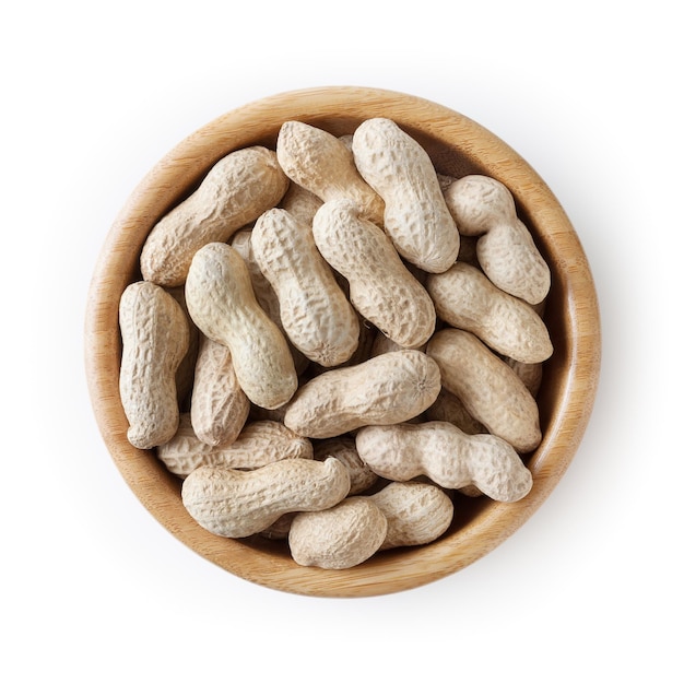 Raw peanuts in wooden bowl isolated on white background with clipping path