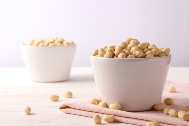 Raw peeled peanuts on a light background