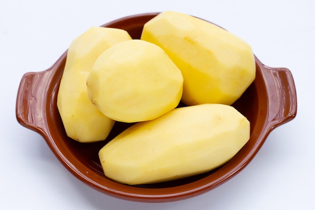 Raw peeled potatoes on white background