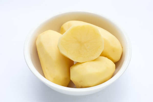 Raw peeled potatoes on white background