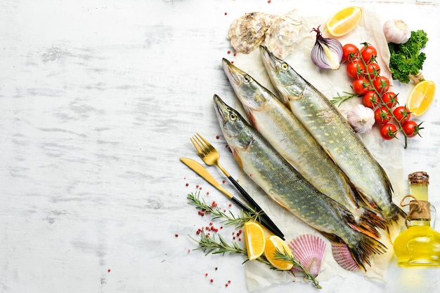 Raw pike fish with spices On a white wooden background Top view