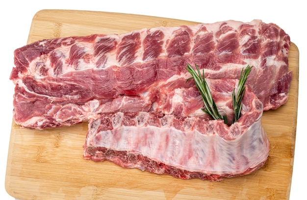 Raw Pork Baby Back Ribs On The Cutting Board Racks of fresh raw pork meat ribs isolated on white background