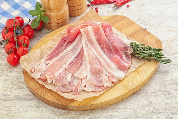 Raw pork bacon for roast or grill