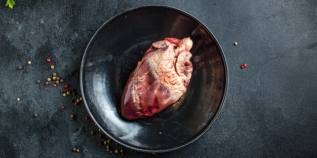 raw pork or beef heart piece of meat second course snack ready to eat