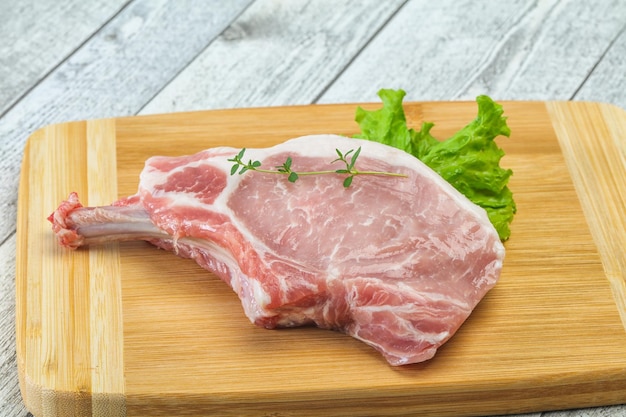 Raw pork bone steak over wooden