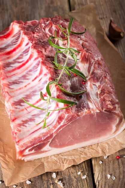 Raw pork chop on wooden table