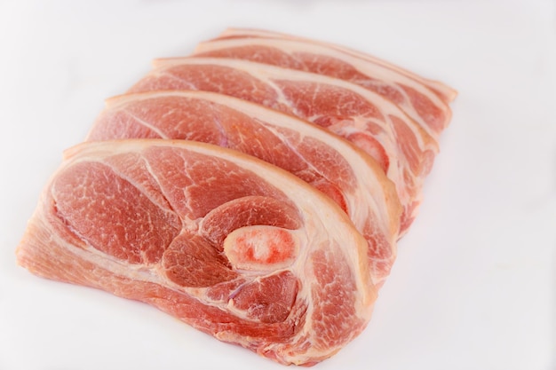 Raw pork chops bone in isolated on white background