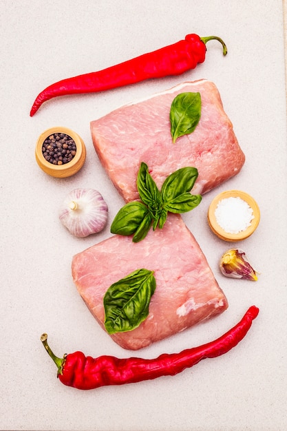 Raw pork meat loin with fresh vegetables and dry spice