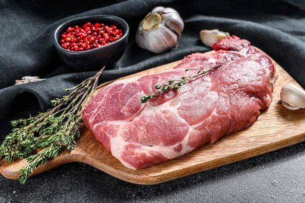 Raw pork meat steak near spices