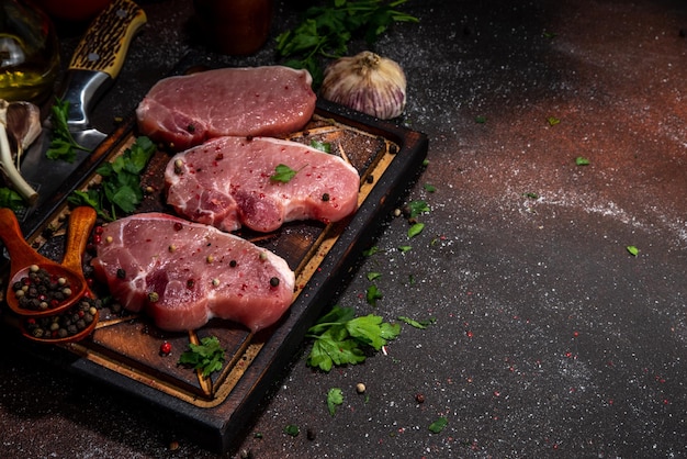 Raw pork meat steaks cooking background