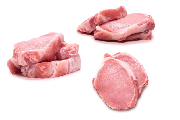 Raw pork pieces isolated on a white background. Top view.