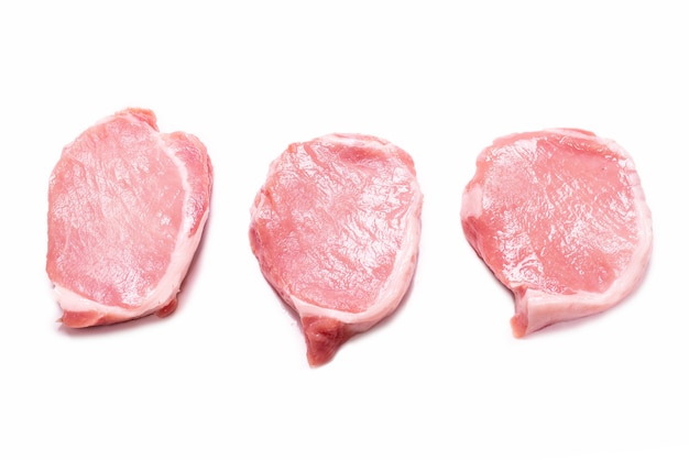 Raw pork pieces isolated on a white surface