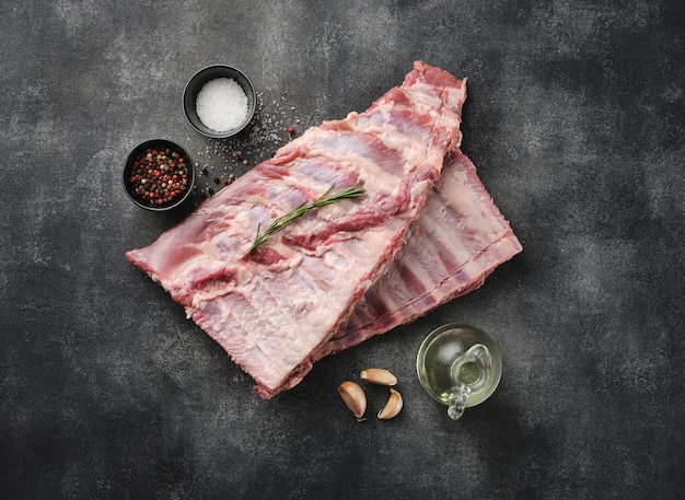 Raw pork ribs with spices salt pepper and rosemary Fresh pork Pig ribs