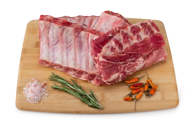 Raw pork ribs with spices salt and rosemary on wooden background Fresh raw pork ribs with ingredients